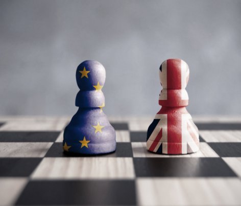 Two chess pawns with UK and European flags Two chess pawns with UK and European flags