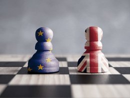 Two chess pawns with UK and European flags