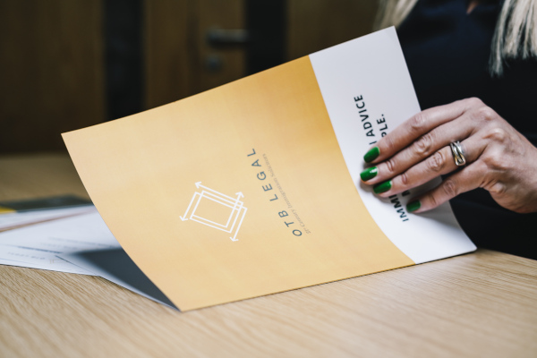 Turning the page of OTB Legal Immigration book for indefinite leave to remain